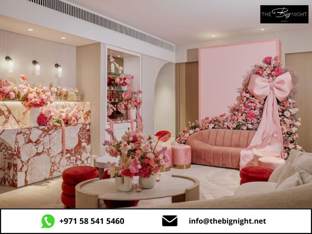 Elegant pink floral event setup with modern decor, plush seating, and marble accents at The Big Night venue.