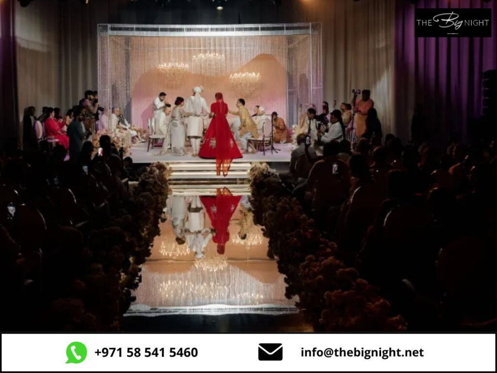 Elegant wedding ceremony with a couple under chandeliers, surrounded by guests. Contact info at bottom.