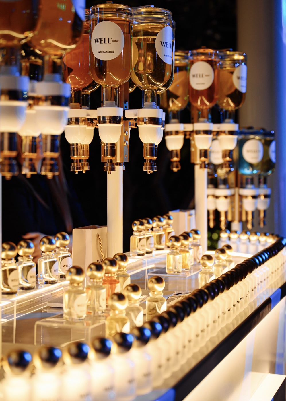 Luxury perfume bottles with gold caps displayed elegantly under warm lighting.