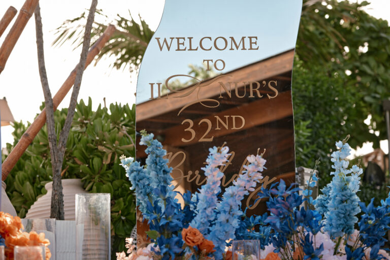 Elegant 32nd birthday decor with floral arrangements and custom welcome sign.