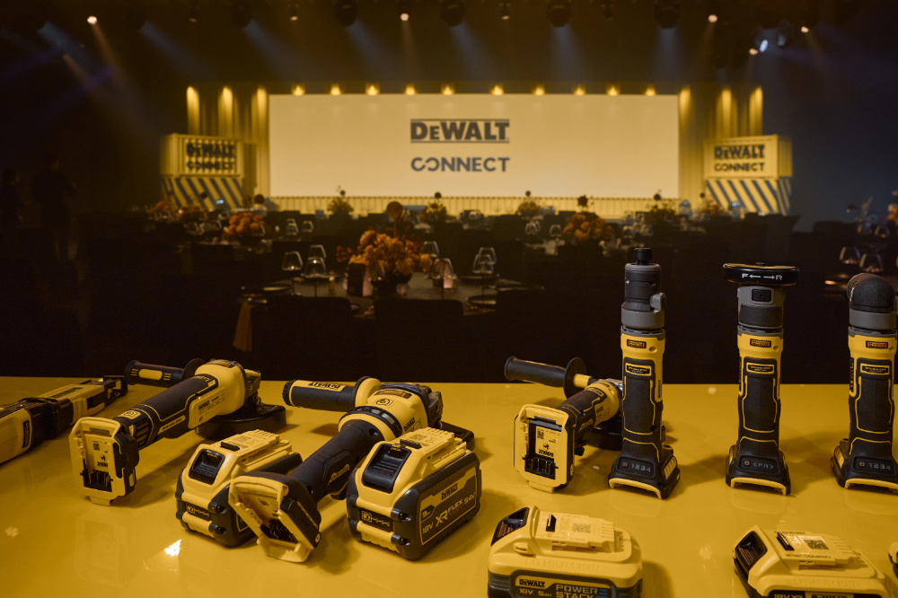 DeWalt tools displayed at an event, showcasing new product line on a stage with DeWalt Connect branding.